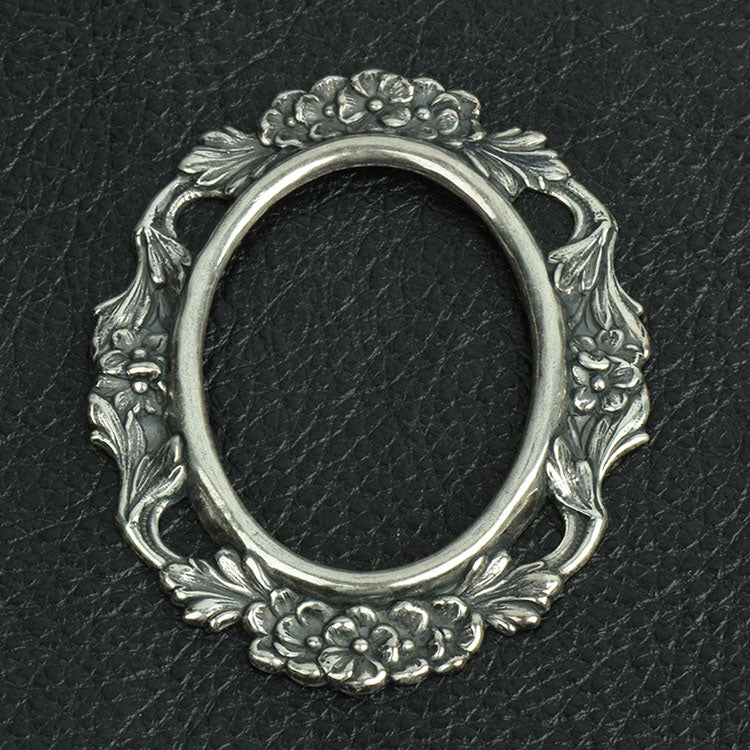 Stamped metal ornate border open center, sold by ea