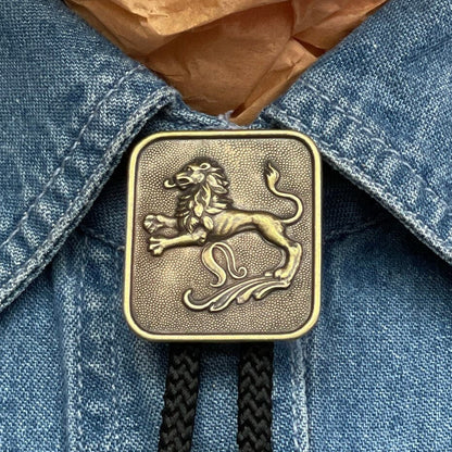 Lion Leo Bolo Tie in antique gold with matching tips. Choose jute, black, red, turquoise, or olive green 36" cord, made in USA, Each